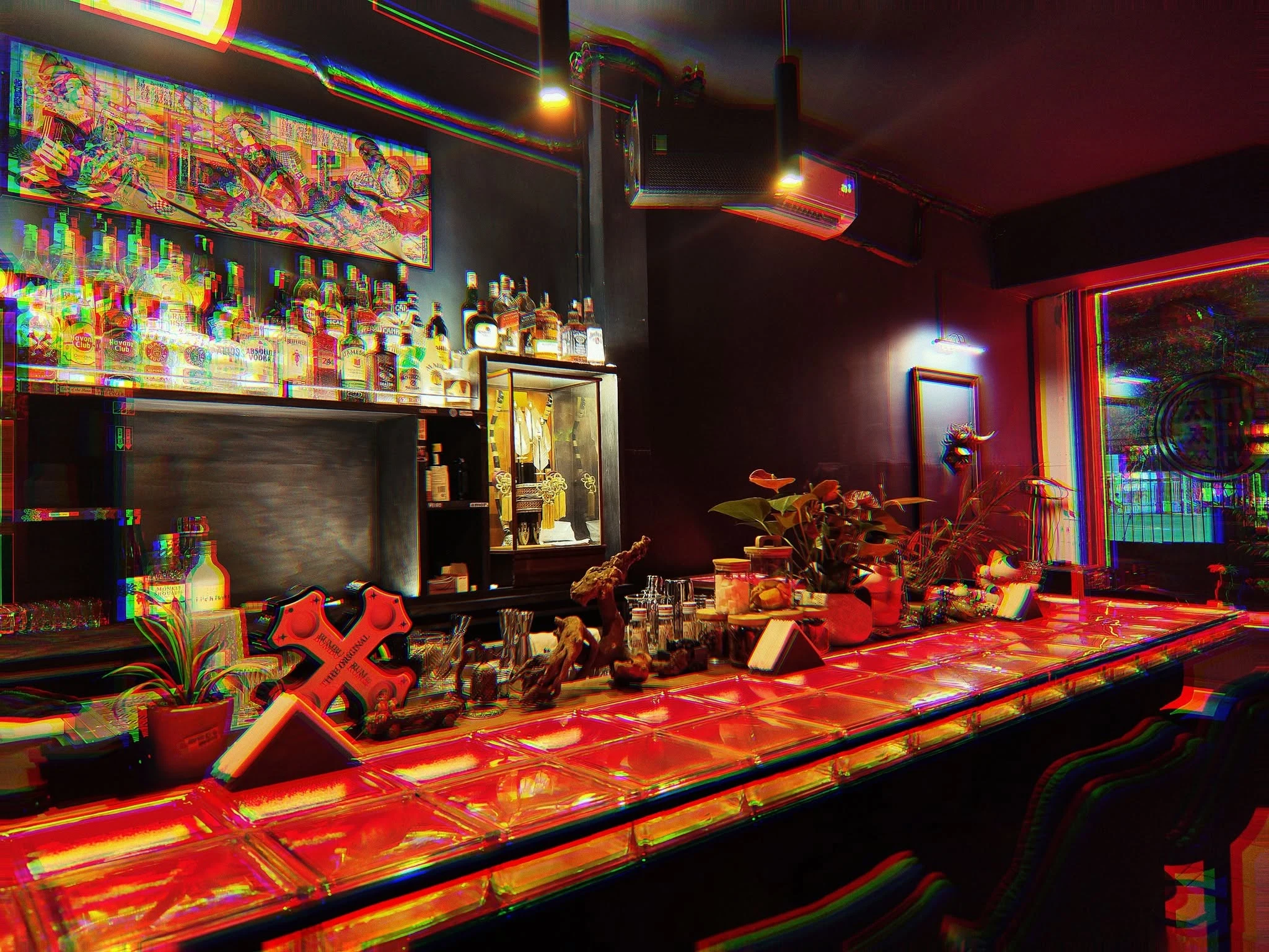Cocktail glass at a dark bar counter